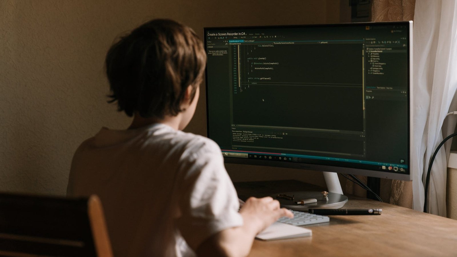 person in white shirt using computer