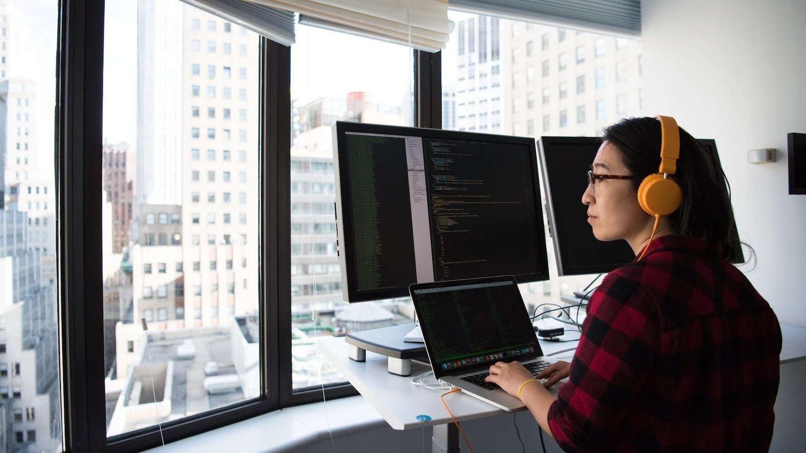 woman sitting while operating macbook pro