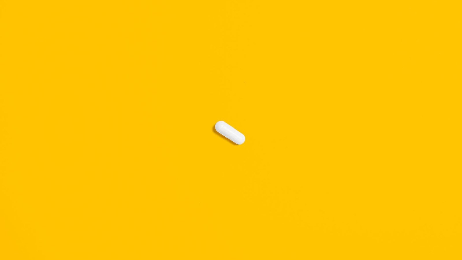white pill on yellow surface